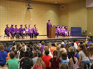 Graduates on stage at an assembly