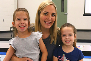Mom with daughters at Kindergarten event